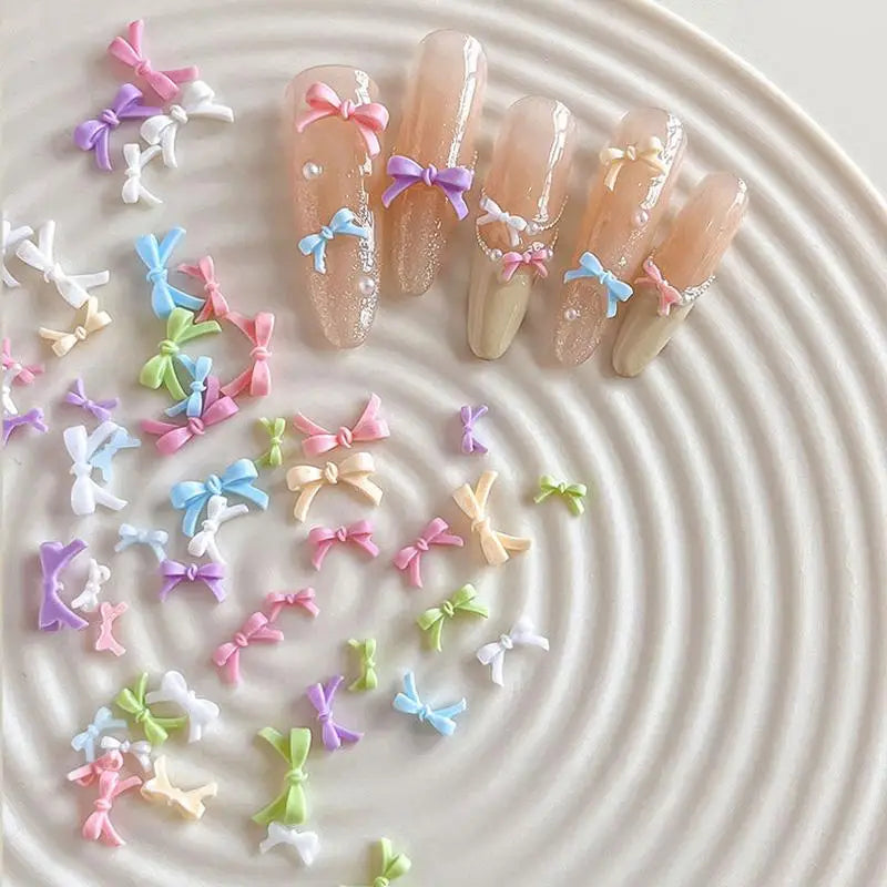 50pcs Colorful Bow Nail Art Parts Charms Bulk Shiny Mini Resin Ribbon Nail Rhinestones DIY Summer Nail Art Decor Accessories Vue