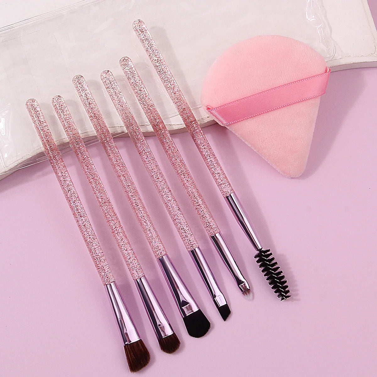 6pcs soft bristle multi-functional eye brush with glitter handle +1pcs triangular powder puff +1pcs portable pvx storage bag Vue